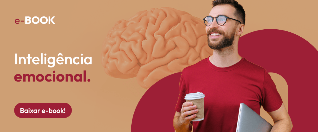 imagem com fundo na cor bege, do lado esquerdo temos a seguinte frase: "Inteligência Emocional". Do lado direito, temos o M do logo da Microlins na cor vinho e a frente dele, temos um homem branco, barbudo, sorridente, usando óculos e segurando um café.